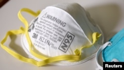 FILE - Various N95 respirator masks are seen at a 3M laboratory, in Maplewood, Minnesota, March 4, 2020. 