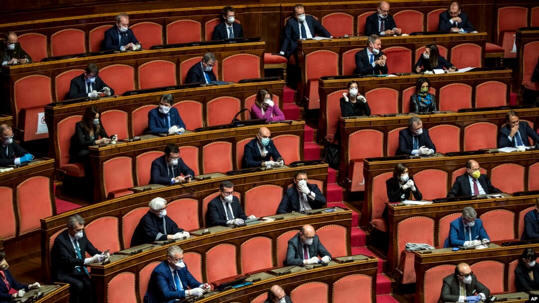 Senators, most wearing face masks, listen as Italian premier Giuseppe Conte informs them on coronavirus situation, in Rome, March 26, 2020. 