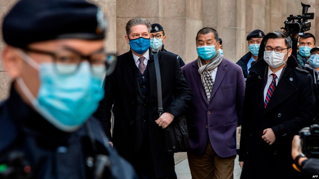 Hong Kong pro-democracy media tycoon Jimmy Lai, center right, leaves the Court of Final Appeal in Hong Kong on Dec. 31, 2020.