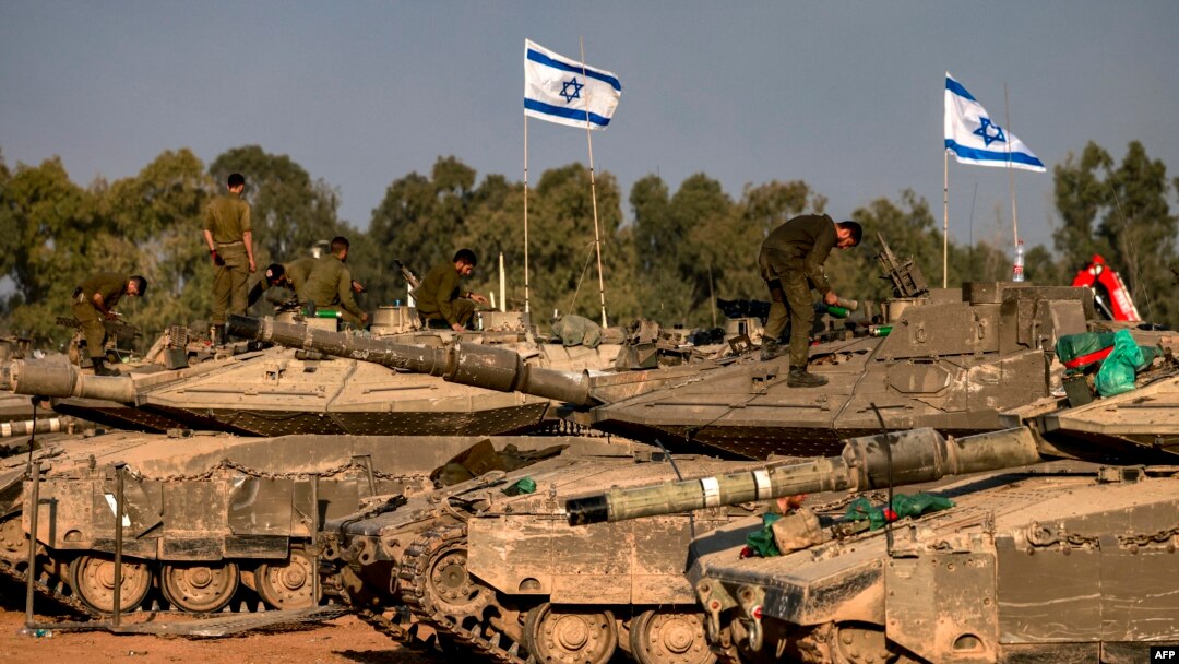 Israeli battle tanks are deployed at a position along the border with the Gaza Strip and southern Israel on Dec. 31, 2023.