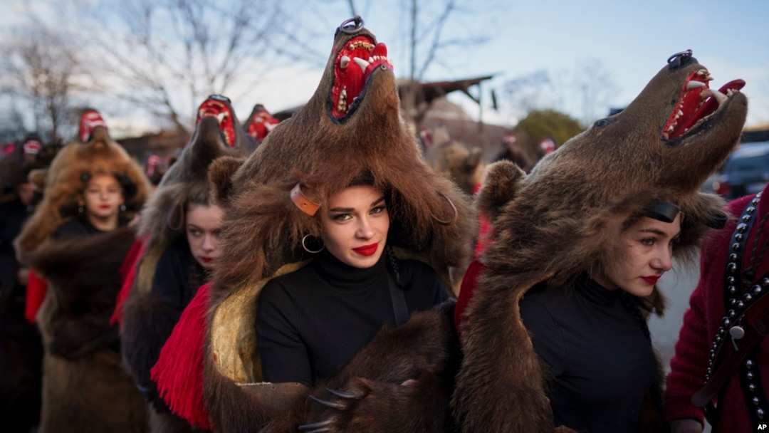 Members of a traditional bear pack take part in a parade before performing in a festival in Moinesti, northern Romania, Dec. 27, 2023. 