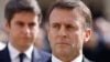 FILE - French President Emmanuel Macron and French Prime Minister Gabriel Attal, background, attend a ceremony in Paris, March 20, 2024. Following a snap legislative election, Macron has lost his parliamentary majority.