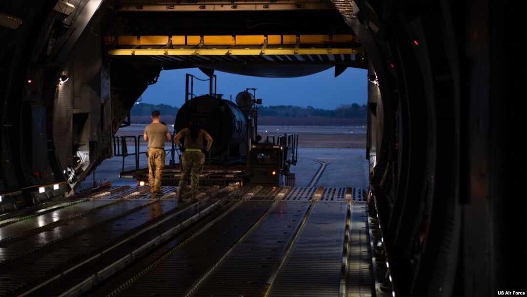 FILE - Airmen assigned to the 437th Aerial Port Squadron, load equipment bound for Ukraine onto a C-5 Super Galaxy at Joint Base Charleston, South Carolina, Jan. 31, 2023.