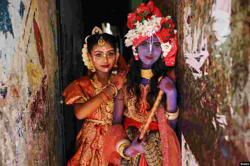 Hindu girls dressed as Radha and Lord Krishna during the Janmashtami festival, pose for a picture as the Hindu community celebrates the birth anniversary of Lord Krishna in Dhaka, Bangladesh.