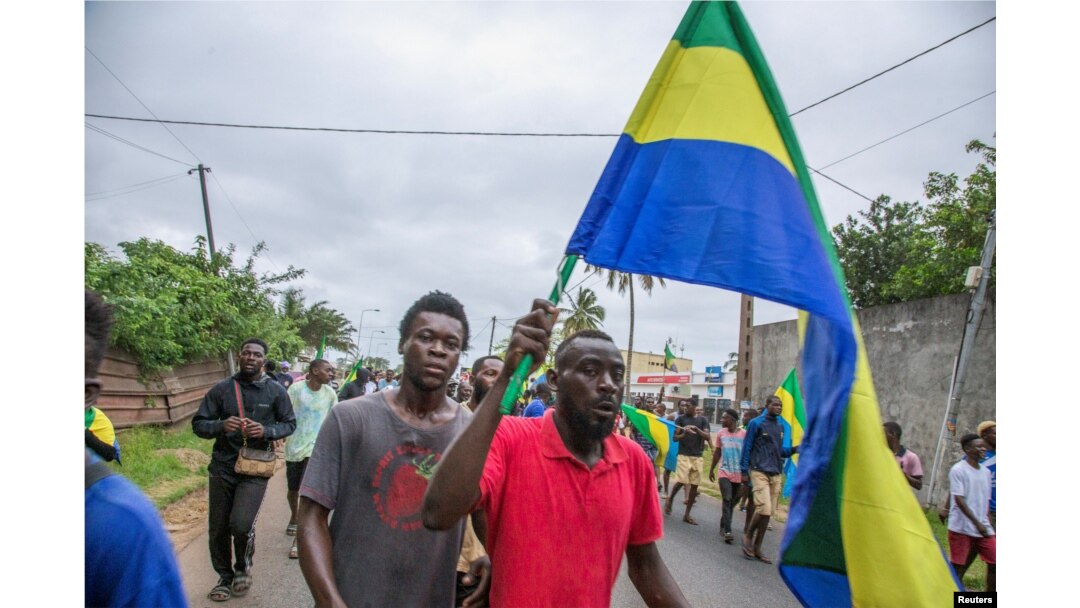 People celebrate in support of the coup leaders in a street of Port-Gentil, Gabon Aug. 30, 2023.