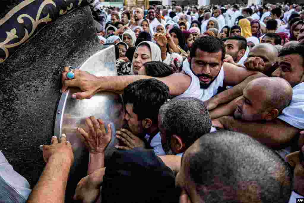 Muslim worshippers approach to kiss and touch the Hajar al-Aswad ("Black Stone"), a rock set into the eastern corner of the Kaaba which is believed to be the only piece remaining from an altar built by the patriarch Abraham, at the Grand Mosque in Saudi Arabia's holy city of Mecca.