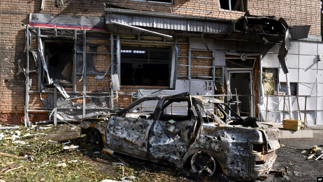 A burned car is seen in front of an apartment building damaged after shelling by the Ukrainian side in Kursk, Russia, Aug. 11, 2024. 