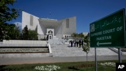 FILE - Lawyers are seen gathered outside Pakistan's Supreme Court in Islamabad, April 4, 2023. 
