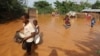 FILE - Children flee floodwaters that wreaked havoc at Mororo, at the border of Tana River and Garissa counties, Kenya, April 28, 2024. 