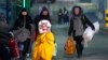 FILE - People fleeing the conflict in neighboring Ukraine cross the border in Przemysl, Poland, Feb. 27, 2022. 