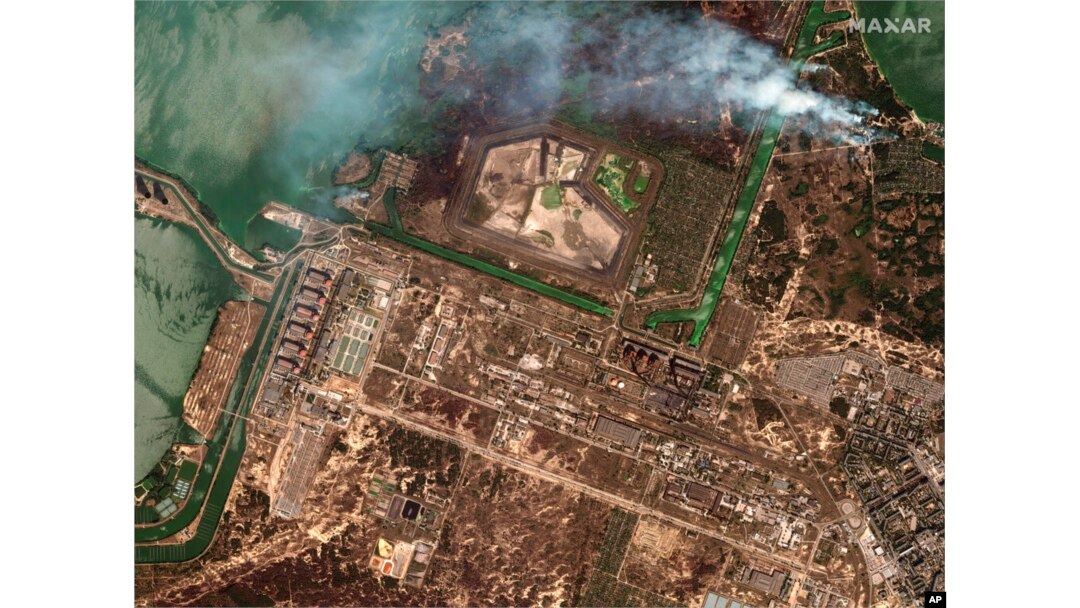 FILE - This satellite image provided by Maxar Technologies shows bush fires outside of the main power plant facilities at the Zaporizhzhia nuclear plant in Russian-occupied Ukraine, Aug. 29, 2022.
