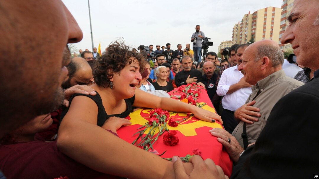 A relative cries over the coffin of Korkmaz Tedik, 25, killed in Saturday's bombing attacks, during his funeral at the Pir Sultan Abdal Cemevi, a place of worship for Turkey’s Alevi community in the outskirts of Ankara, Oct. 11, 2015.