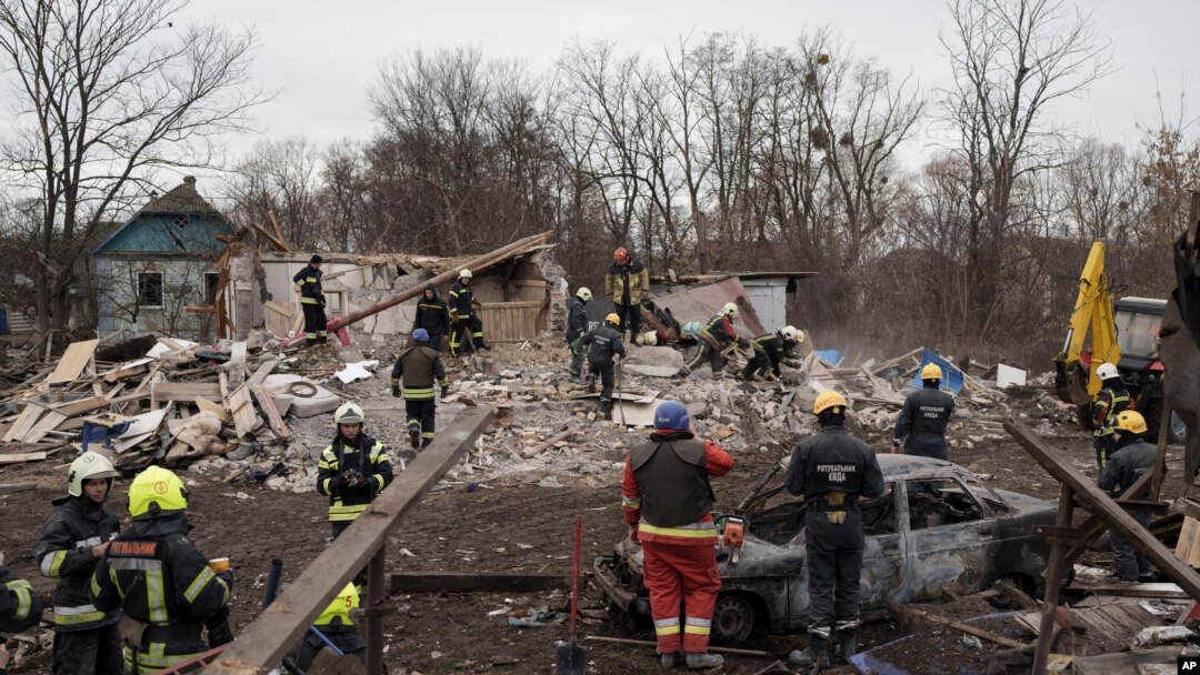 Emergency workers remove debris of a house destroyed following a Russian missile strike in Kyiv, Ukraine, Dec. 29, 2022. 