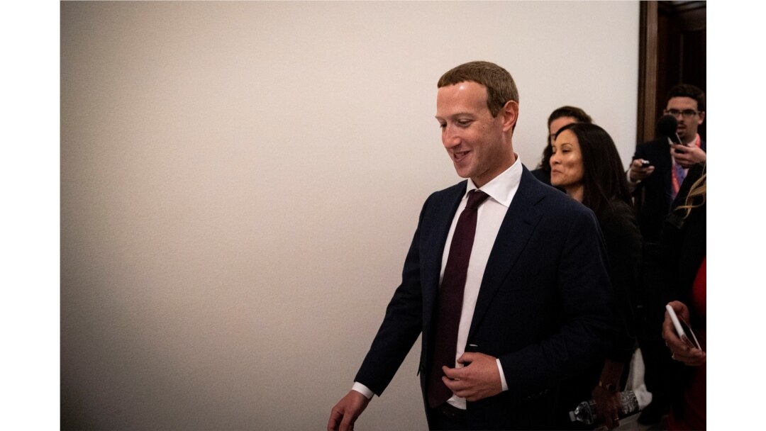 Facebook Chief Executive Mark Zuckerberg walks past members of the news media between meetings with lawmakers on Capitol Hill in Washington, Sept. 19, 2019.