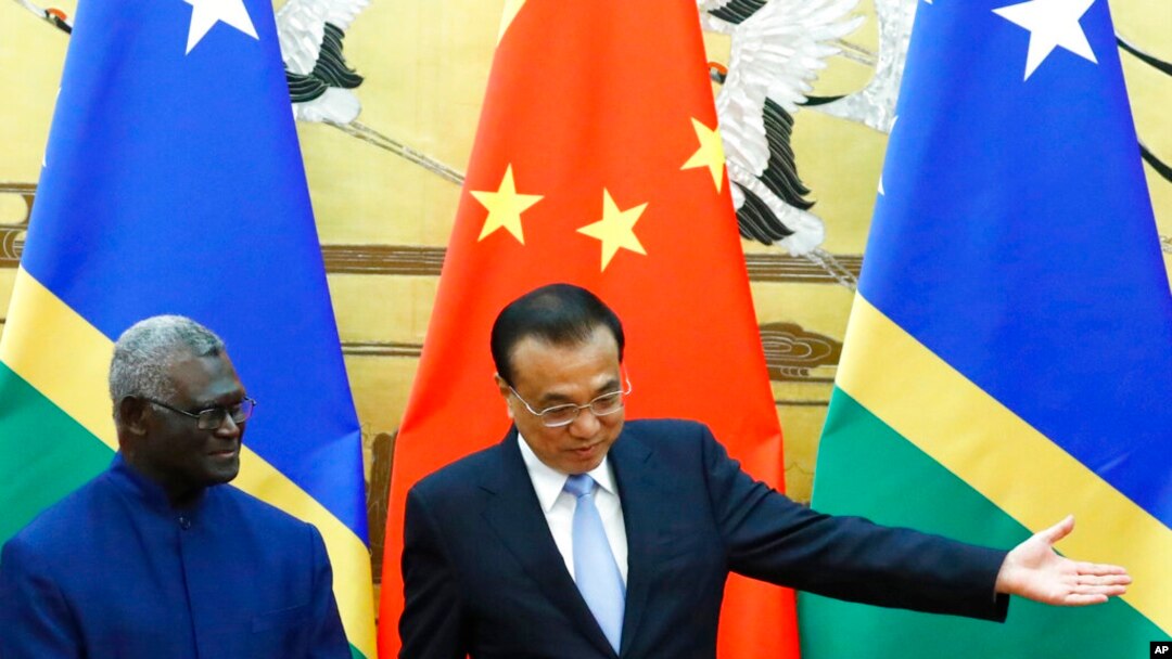 FILE - Solomon Islands Prime Minister Manasseh Sogavare, left, and Chinese Premier Li Keqiang attend a signing ceremony at the Great Hall of the People in Beijing, Oct. 9, 2019.
