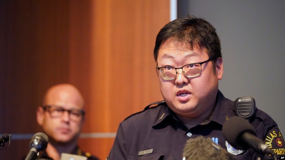 Dallas Police senior corporal Soo Kim addresses reporters in Korean as police Chief Eddie Garcia, left, looks on during a news conference at police headquarters headquarters in Dallas, May 17, 2022. Photo by AP