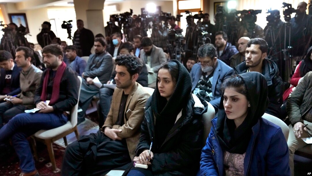 FILE - Afghan journalists attend a press conference of a former President Hamid Karzai in Kabul, Afghanistan, Feb. 13, 2022.