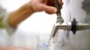 An official at the Carlsbad Desalination plant fills a cup with filtered water made from ocean water, May 26, 2022, in Carlsbad, Calif.