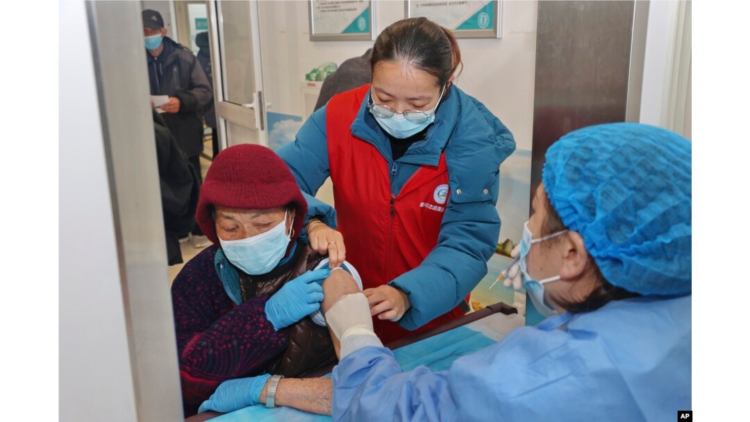 An elderly woman gets vaccinated against COVID-19 at a community health center in Nantong in eastern China's Jiangsu province on Dec. 9, 2022. (Chinatopix Via AP)