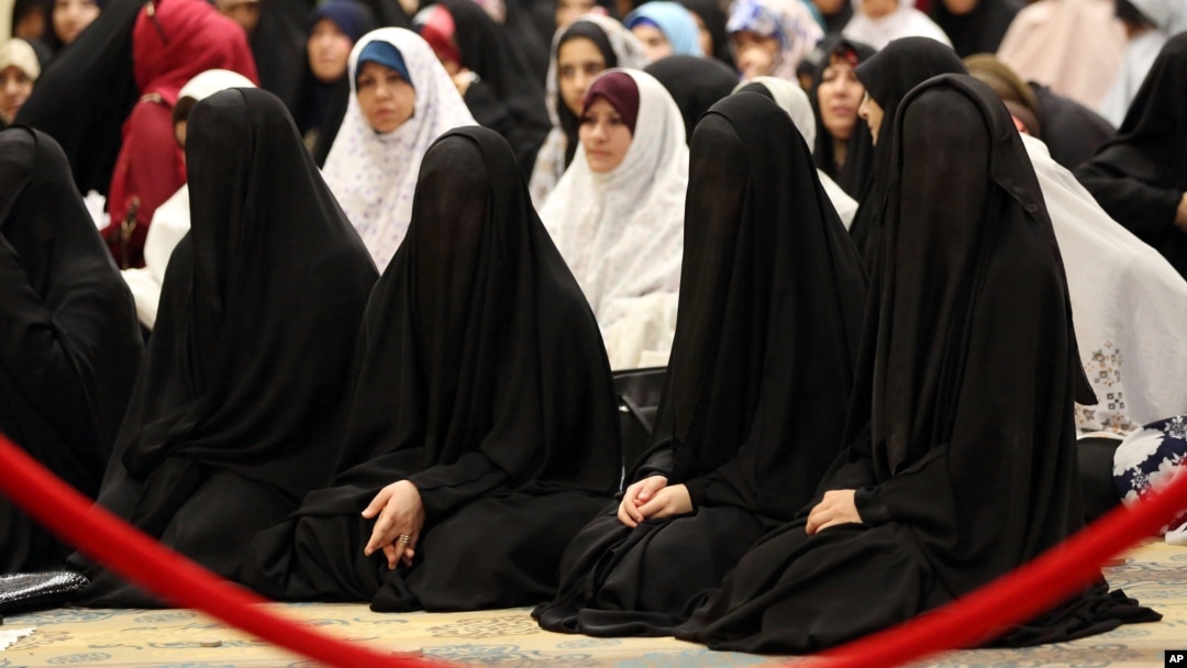 FILE - Iraqi Shiite women take part in the Eid al-Fitr prayer in Baghdad, Iraq, July 29, 2014. Islamic State is imposing a strict dress code on women in Iraq and Syria during Ramadan.