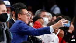 FILE - Brooklyn Nets owner Joe Tsai takes a picture during the second half of an NBA basketball game against the Sacramento Kings, Feb. 14, 2022, in New York.
