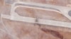 This satellite photo shows run damage after an Israeli strike targeted the Aleppo International Airport, Sept. 1, 2022. The attack also damaged a nearby piece of tarmac and a structure on the military side of the Syrian airport. (Planet Labs PBC via AP)
