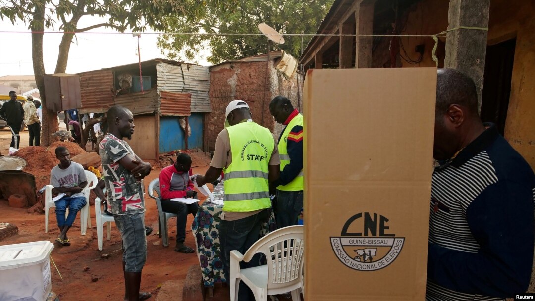 A man prepares to cast his ballot at a polling station during the second round of Guinea Bissau's presidential election in Bissau, Guinea-Bissau, Dec. 29, 2019.