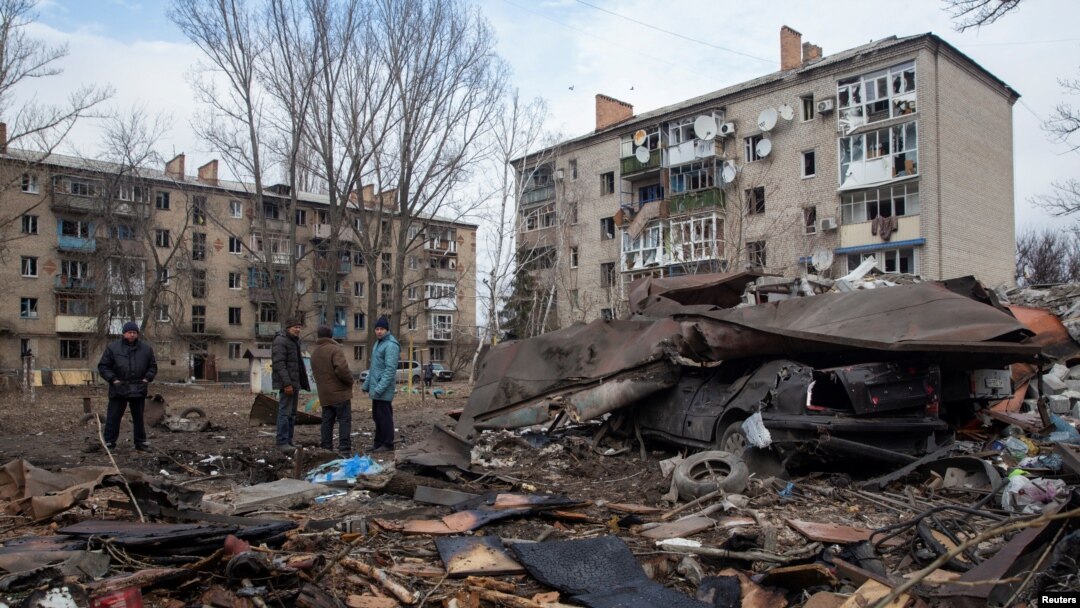 Local residents stand at a site of a Russian missile strike, amid Russia's attack on Ukraine, in Kostiantynivka, Donetsk region, Ukraine, Jan, 28, 2023. 