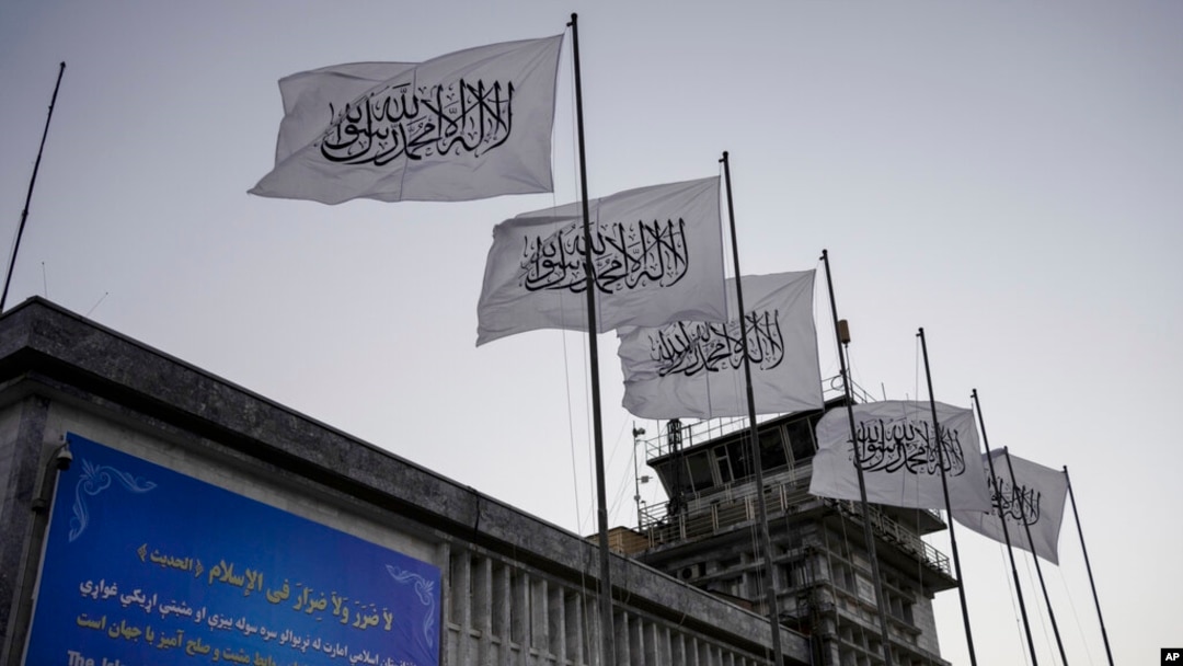 FILE - Taliban flags flutter at the airport in Kabul, Afghanistan, Sept. 9, 2021. 