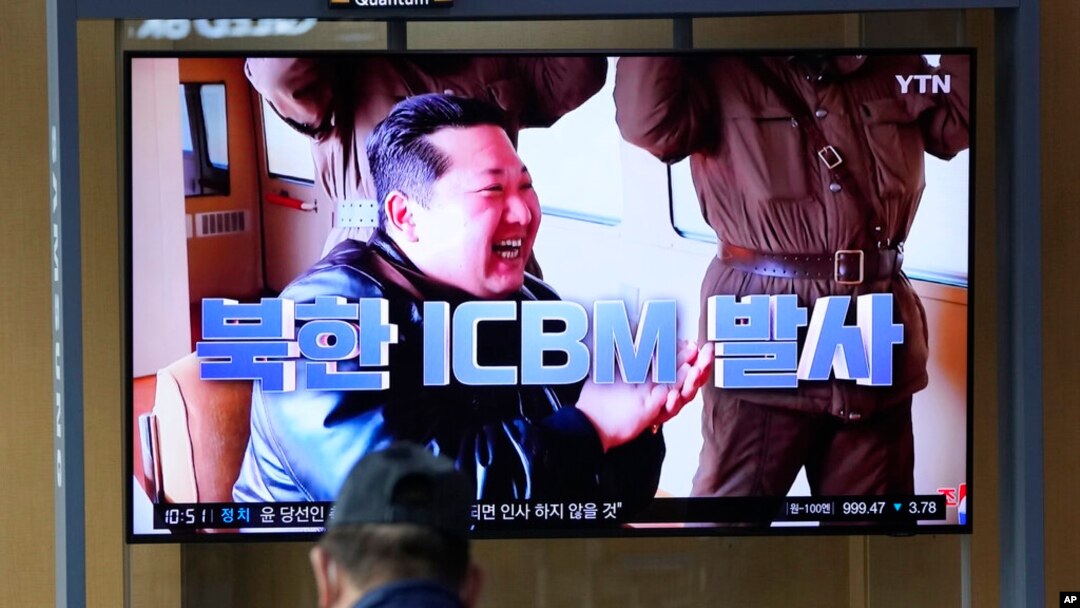 FILE - A man watches a TV screen showing a news program reporting about North Korea's ICBM with an image of North Korean leader Kim Jong Un at a train station in Seoul, South Korea, March 25, 2022