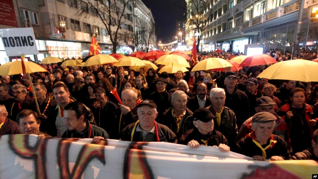 Protesters carrying umbrellas in colors of the national flag march through a street in Skopje, Macedonia, March 10, 2017. Thousands of Macedonians have been protesting against the designation of Albanian as a second official language nationwide.