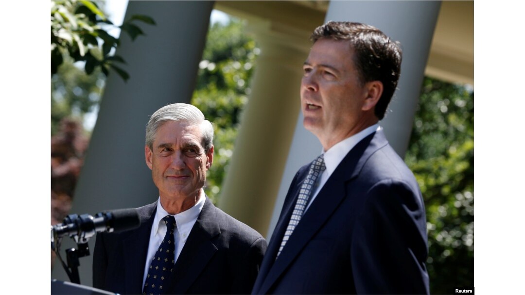 FILE - James Comey, right, a Republican who served in President George W. Bush's Justice Department, speaks alongside outgoing FBI Director Robert Mueller in the Rose Garden of the White House in Washington, June 21, 2013.