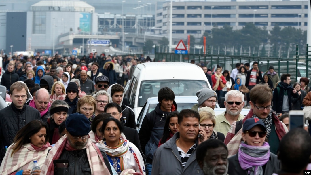 Passengers are evacuated from Brussels airport, on March 22, 2016 in Zaventem, after at least 13 people were killed and 35 injured as twin blasts rocked the main terminal of Brussels airport.