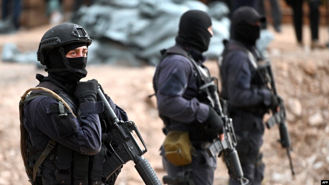 FILE - Georgian special police patrol the Georgian-South Ossetian border at a check point in the Kvemo Kartli region some 120 km outside Tbilisi on Aug. 30, 2019.