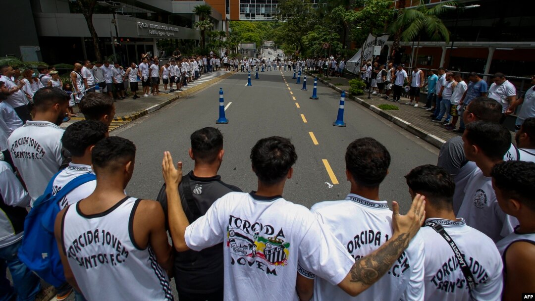 Fans of Santos attend a vigil outside the Albert Einstein Israelite Hospital where Brazilian football legend Pele is hospitalized in Sao Paulo, Brazil, on Dec. 4, 2022.