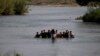FILE - Migrants, mostly from Nicaragua, cross the Rio Grande into the U.S., at Eagle Pass, Texas, May 20, 2022. 