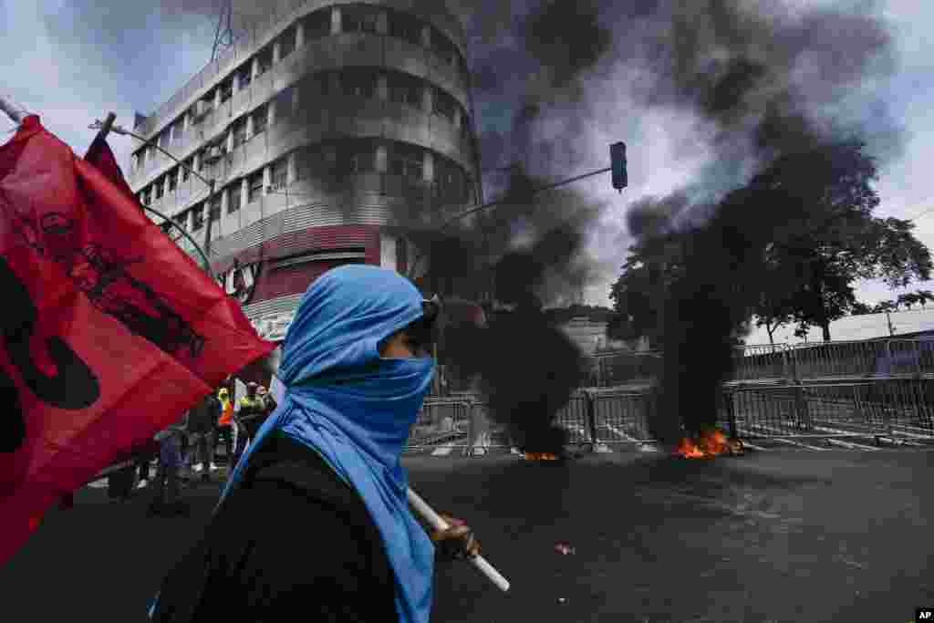 Construction union workers protest in support of striking teachers, outside the National Assembly in Panama City, Panama.