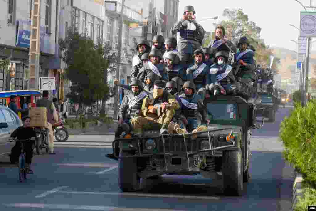 Newly recruited Taliban fighters parade in armored vehicles after their graduation ceremony in Herat, Afghanistan, Sept. 13, 2022.