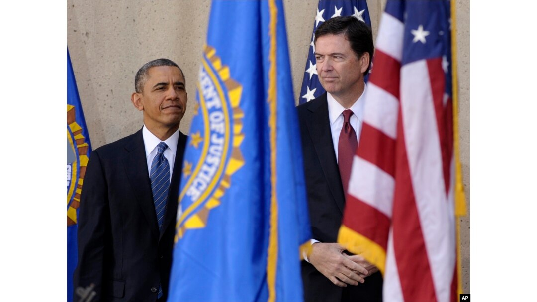 FILE - President Barack Obama stands with James Comey during the presentation of colors at Comey's installation as FBI Director, Oct. 28, 2013, at FBI Headquarters in Washington.