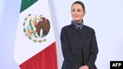This handout picture released by the Mexican Presidency shows Mexico's President Claudia Sheinbaum looking on during her daily press conference at the National Palace in Mexico City on November 28, 2024. (Photo by Handout / Mexican Presidency / AFP) / RES
