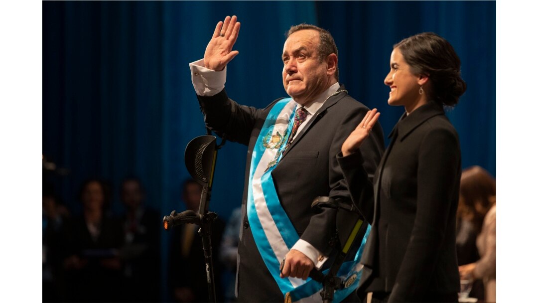 FILE - Alejandro Giammattei, accompanied by his daughter, Ana Marcela, waves to the crowd after he was sworn in as president of Guatemala at the National Theater in Guatemala City, Jan. 14, 2020.