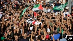 Mourners carry the body of Mohammed Obeid, a 20 year-old Palestinian killed in a clash with Israeli police on June 27, during his funeral in east Jerusalem, July 1, 2019.
