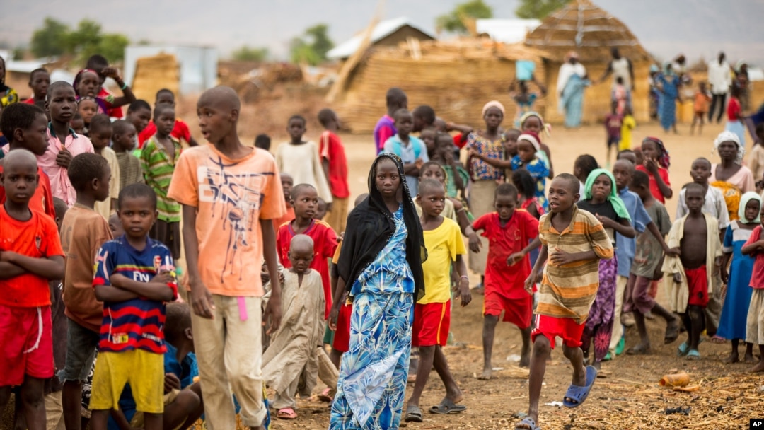 FILE - Refugees are seen gathered at Minawao Refugee Camp in northern Cameroon, Apr. 18, 2016. 