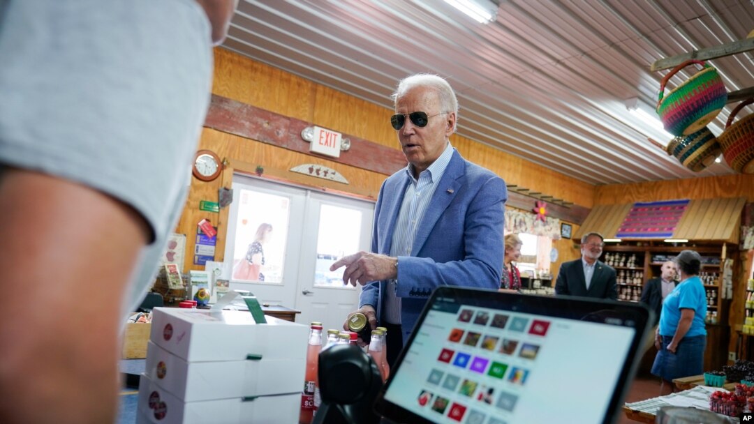 President Joe Biden makes a purchase at the King Orchards fruit farm Saturday in Central Lake, Mich., July 3, 2021. 