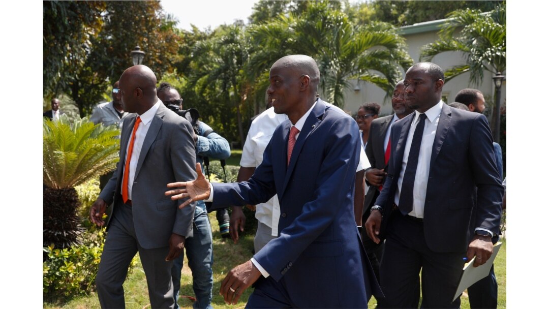 President Jovenel Moïse reaches out to greet journalists after a press conference at the National Palace in Port-au-Prince, Haiti, Oct. 15, 2019.