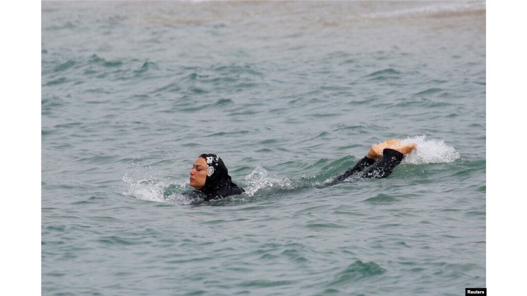 A Muslim woman wears a burkini, a swimsuit that leaves only the face, hands and feet exposed, as she swims in the Mediterranean Sea in Marseille, France, Aug. 17, 2016.