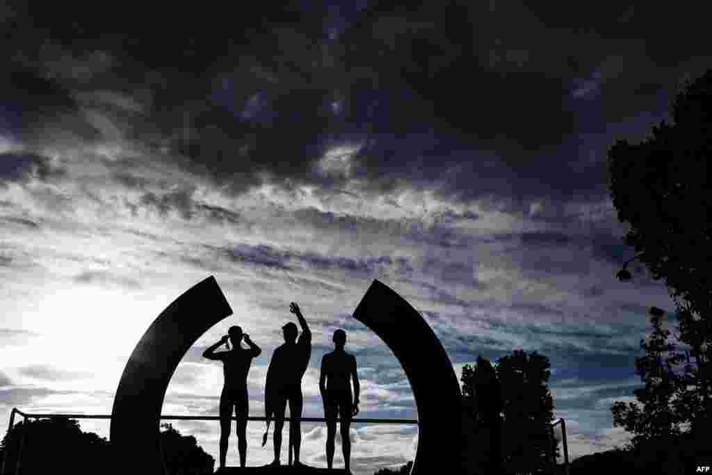 Tour de France 2018 winner Great Britain's Geraint Thomas (C), wearing the overall leader's yellow jersey, second-placed Netherlands' Tom Dumoulin (L) and third-placed Christopher Froome of Great Britain (R) celebrate on the podium after the 21st and last stage of the 105th edition of the Tour de France cycling race between Houilles and Paris Champs-Elysees, July 29, 2018.