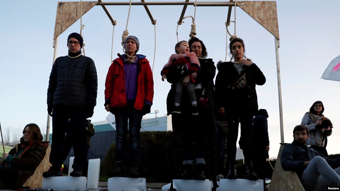 Climate change activists of Extinction Rebellion take part in a performance in front of the U.N. Climate Change Conference (COP25) in Madrid, Spain, Dec. 14, 2019.