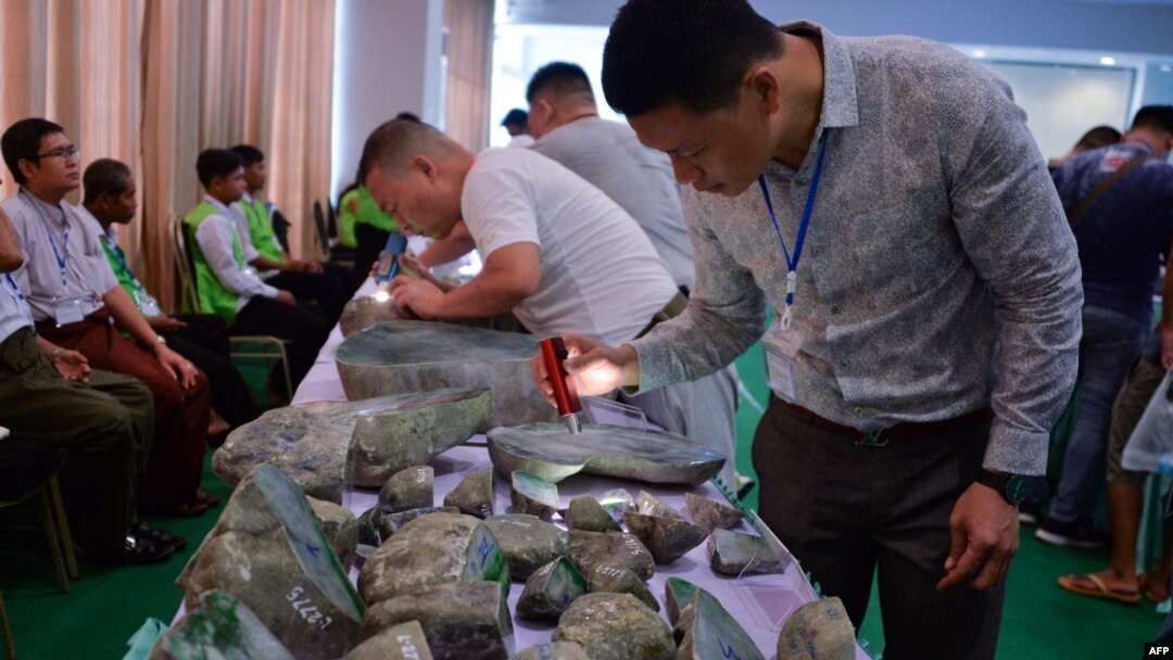 FILE - Buyers checks jade stones before the auction during the annual Myanmar Jade, Gems and Pearl Emporium in Naypyidaw, Sept. 16, 2019. The U.S. has imposed sanctions on Myanma Gems Enterprise (MGE) on April 8, 2021.