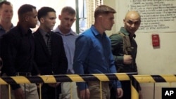 FILE - U.S. Marine Pfc. Joseph Scott Pemberton, third left, the suspect in the killing of Filipino transgender Jennifer Laude, is escorted into the courtroom for his scheduled trial, March 23, 2015, at Olongapo city, Zambales province, northwest of Manila.